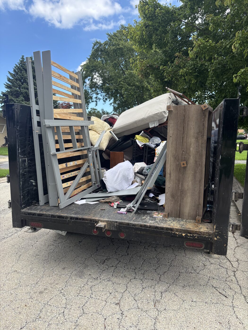 JYD trailer loaded with furniture and household items after a cleanout